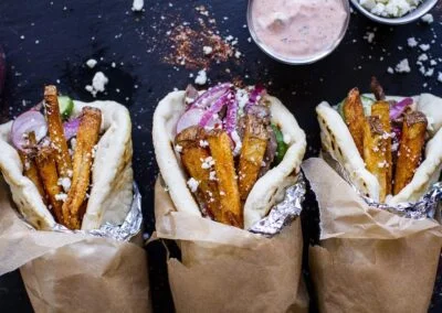 Greek Style Roasted Lamb Gyros with Harissa Spiced Tzatziki